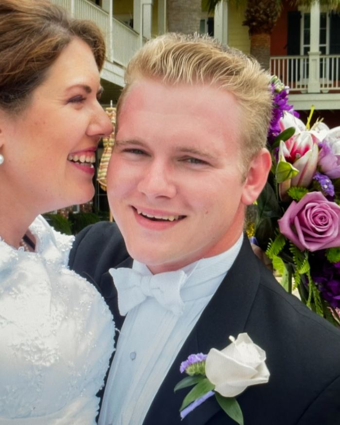 Sam and his bride smiling together on their wedding day