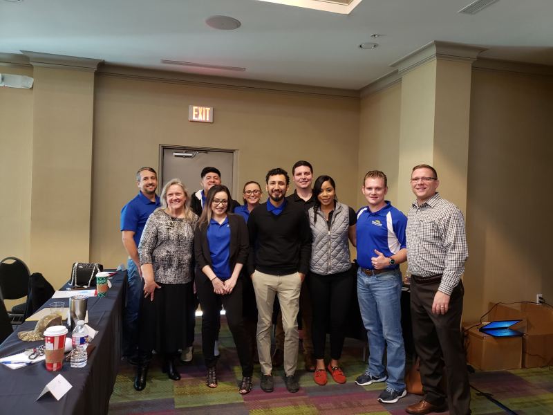 Sam with a group of professionals at a training session