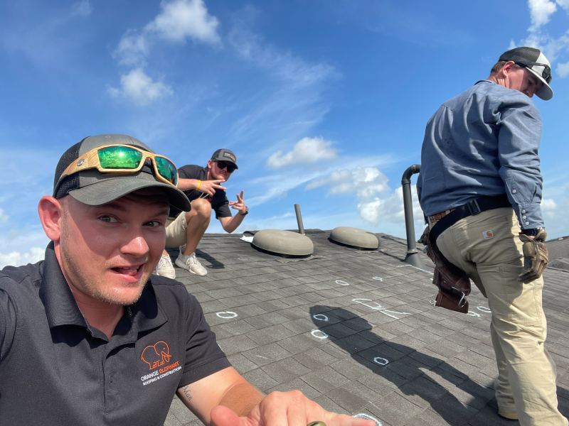 Sam on a roof during an inspection with his team